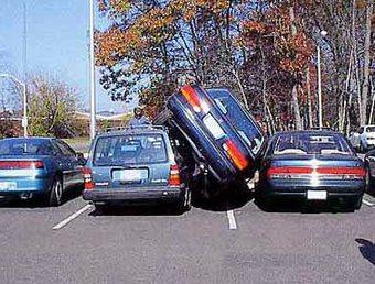 3 cars squeeze into 2 parking spaces